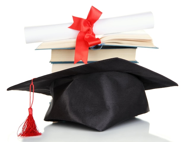 Grad hat with diploma and books isolated on white