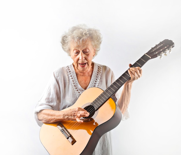 Gradma playing on a guitar