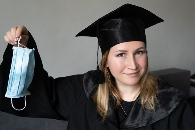 Graduate girl in medical mask at covid