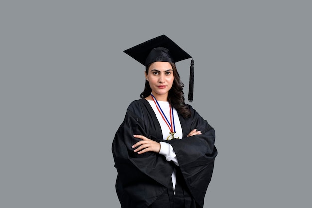 Graduate student girl isolated on grey background indian pakistani model