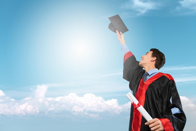 Graduates of the University. Student holding graduation hat