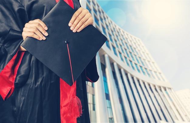 Graduating student girl holding hat