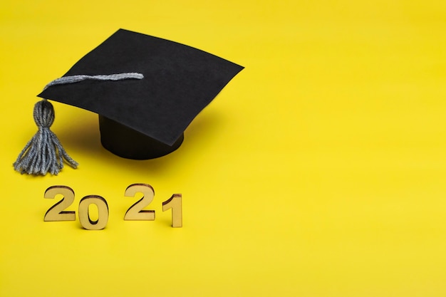 Graduation 2021. Graduate cap on a yellow background. Graduate Template 2021