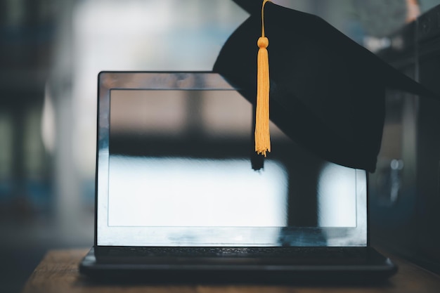 Photo graduation cap put on laptop,concept of computer for education