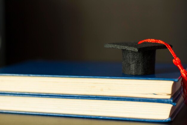 Photo graduation cap on top of books education and graduation concept