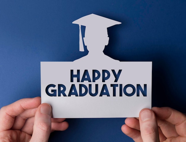 Graduation card Male hands holding card with graduate cutout