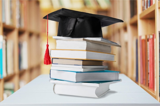 Graduation mortarboard on top of stack of books