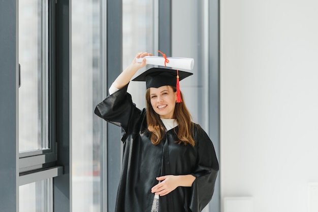 Graduation: student standing with diploma