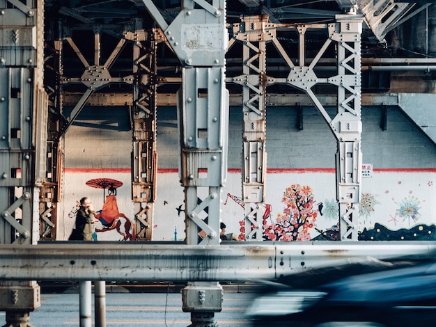 Graffiti on bridge by building in city