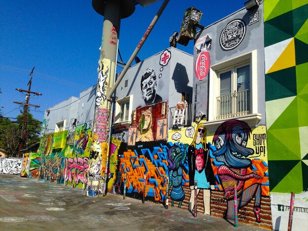 Graffiti on buildings against clear sky