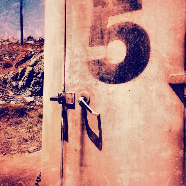 Graffiti on old door of house