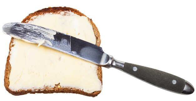 Photo grain bread and butter sandwich with table knife