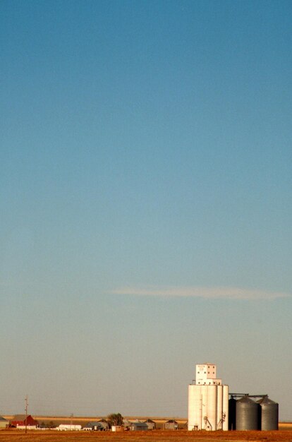 a grain silo in the middle of a field