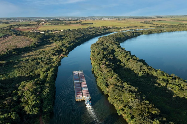 Grain transport barge going up the tiete river tieteparana waterway drone view