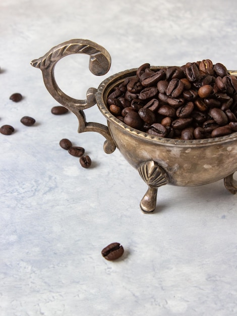 Grains of black coffee on a light white background