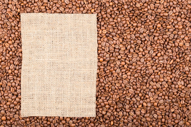 Grains of coffee on which left burlap with copy space