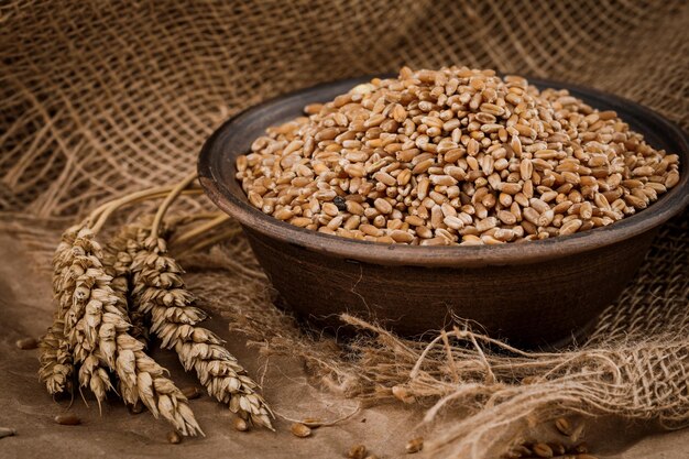 Grains and ears of wheat on Kraft paper and burlap