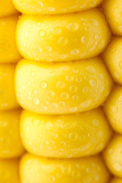 Grains of ripe corn extreme macro yellow background