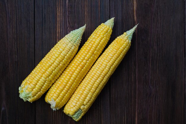 Grains of ripe corn on wooden background