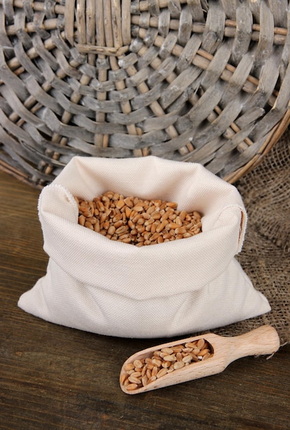 Grains in sack on wooden background