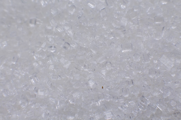 A grains of white sugar macro background for food