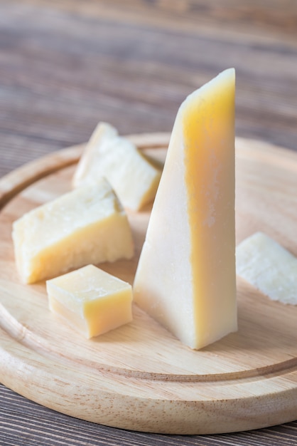 Grana Padano cheese on the wooden board