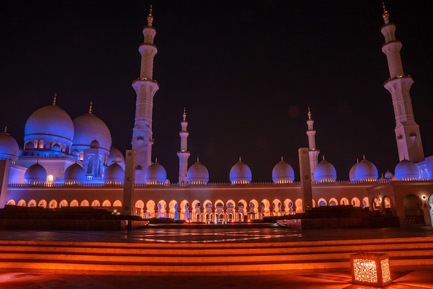 Grand Mosque in Abu Dhabi at night. Panoramic view of exterior of Sheikh Zayed Mosquein UAE with epic lightening.