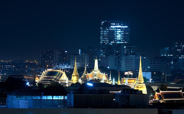 The Grand Palace  illuminate gold light beatifully with surrounded buildings on night scene