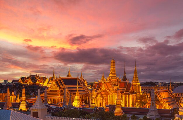 grand palace and wat phra kaew in Bangkok city with sunset sky from roof top of building Thailand