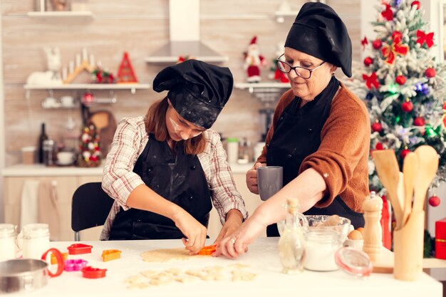 Grandchild using dough shape cutter on christmas day