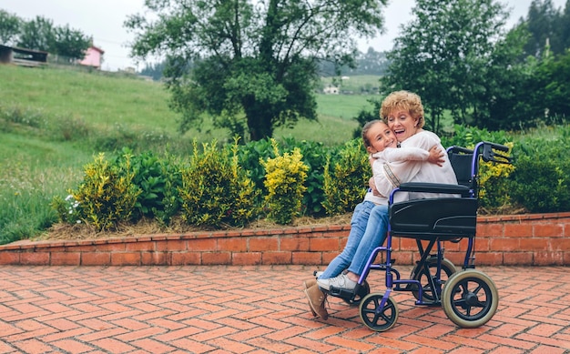 Granddaughter hugging her grandmother in a wheelchair