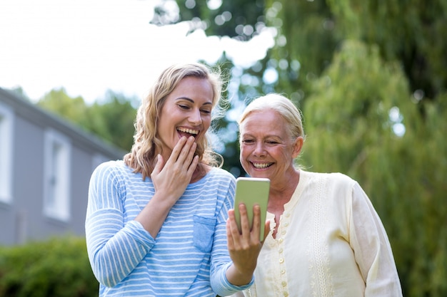 Granddaughter showing phone to grandmother