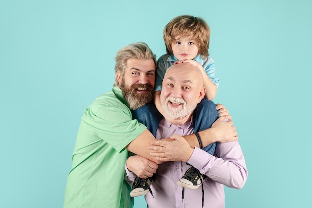 Grandfather father and son hugging and embracing isolated fathers day concept men in different ages