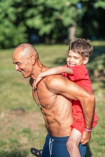 Grandfather and grandson exercising in park