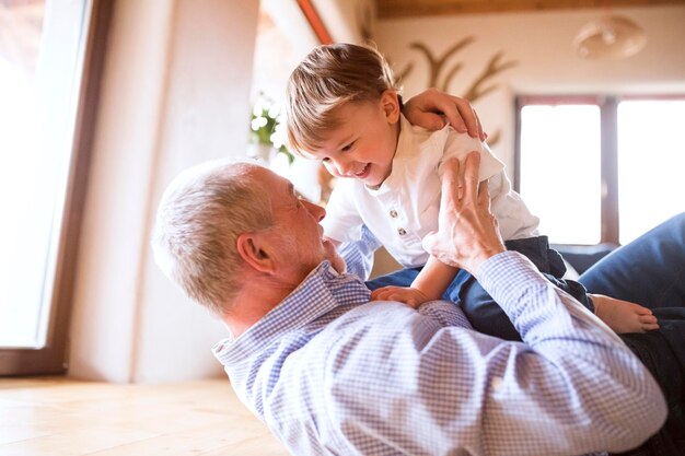 Grandfather and grandson having fun at home