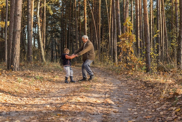 Grandfather  having fun with his grandchild outdoor.