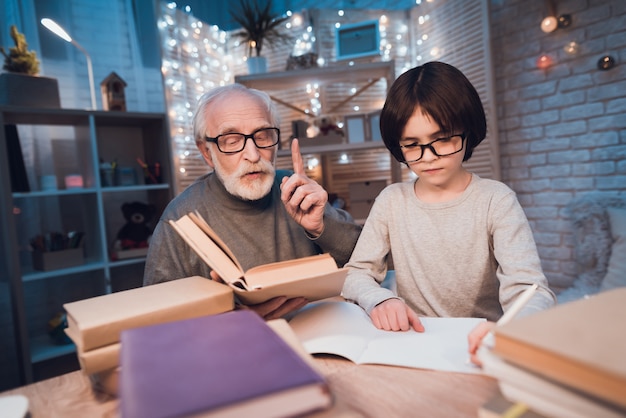 Grandfather Helping Grandson with Doing Homework