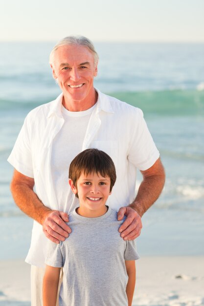 Grandfather and his grandson at the beach