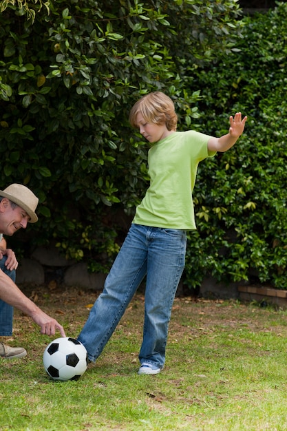 Grandfather and his grandson playing football