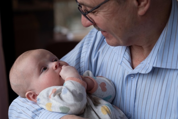 Grandfather holding a beautiful newborn baby girl