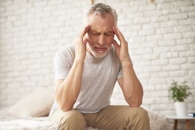 Grandfather Holding Head Blood Pressure Headache.