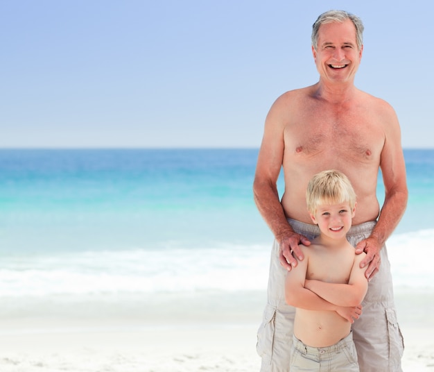 Grandfather with his grandson at the beach