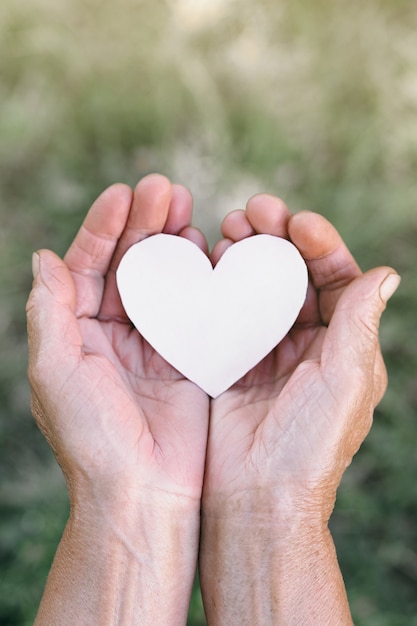 Grandma's hand holds a heart. 