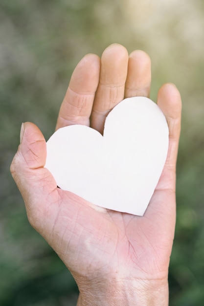 Grandma's hand holds a heart. 