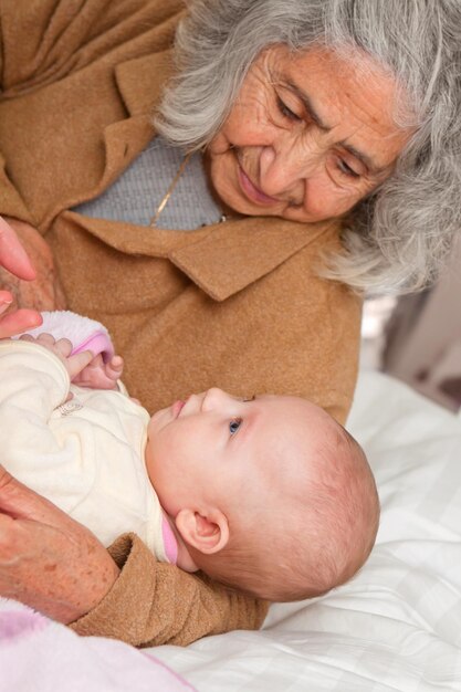 Grandmother carrying girl on bed