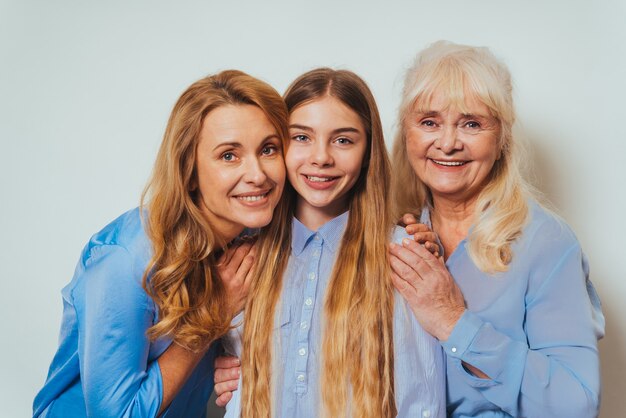 Photo grandmother, daughter and grandchild together at home, happy domestic life moments