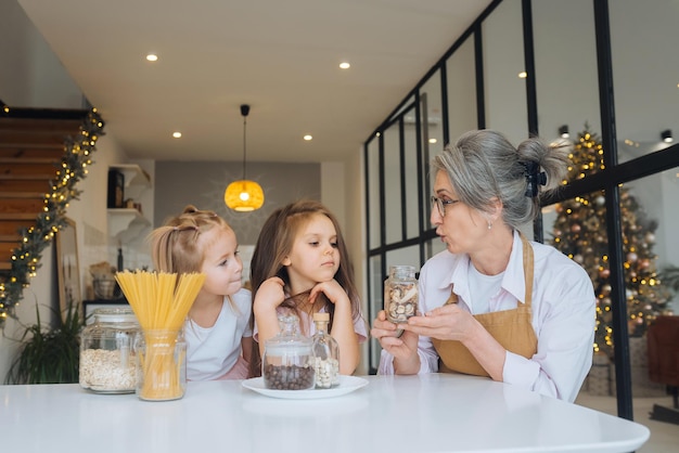 grandmother and granddaughter are cooking on kitchen