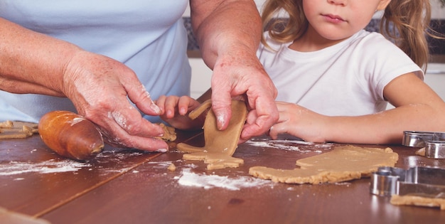 Grandmother and granddaughter cook