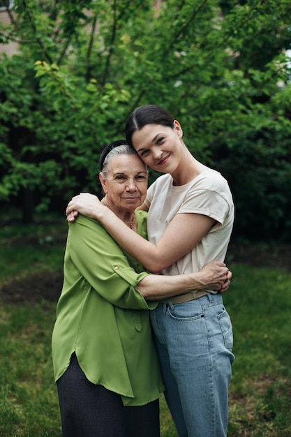 Nonna e nipote che si abbracciano e sorridono in giardino