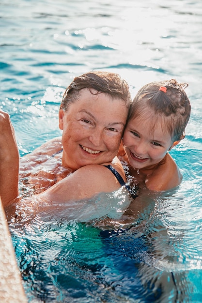 Grandmother and granddaughter in the pool